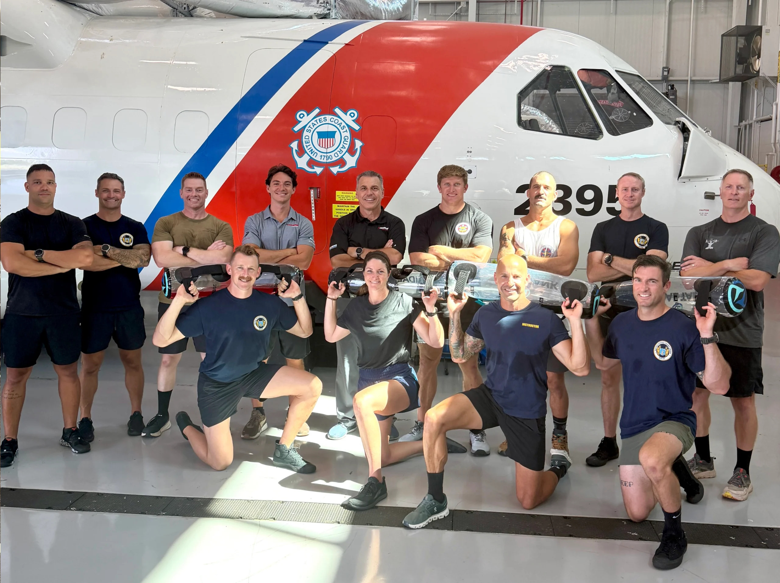 Image of a Coaches standing in front of a coast guard aircraft at an Anatomy of Speed Live Certification at the US Coast Guard Academy in August of 2026